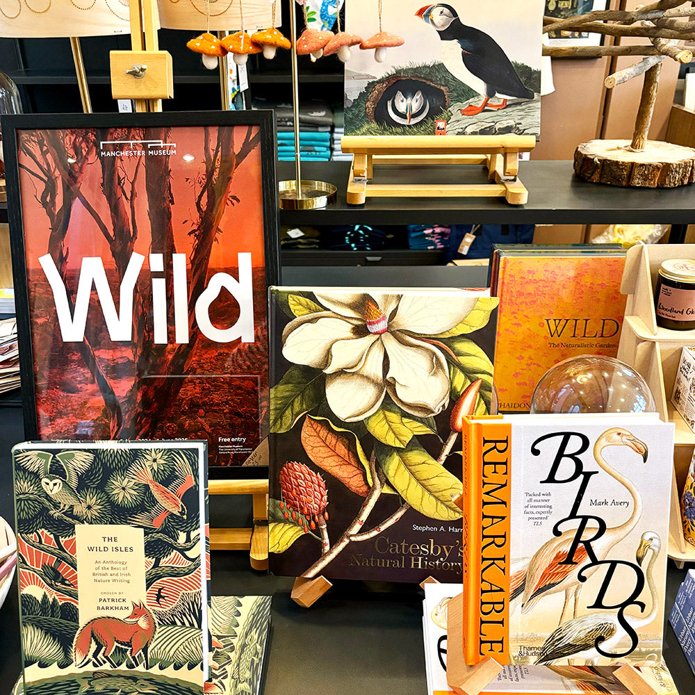 A selection of products on shelves in Manchester Museum, some featuring wild plants or birds.