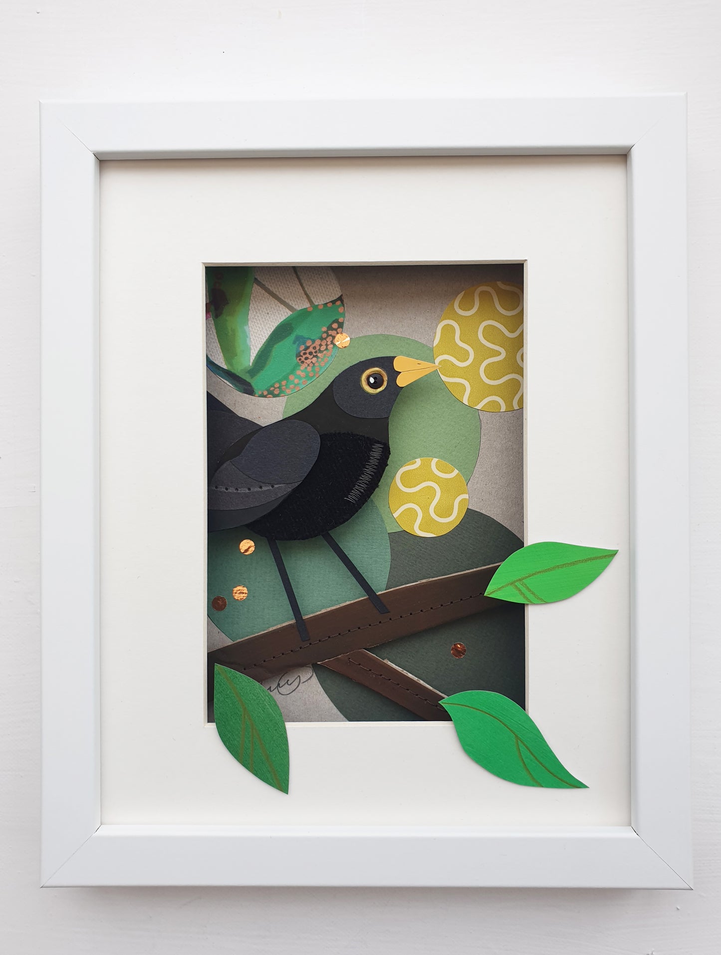 Blackbird artwork hanging on a white wall.