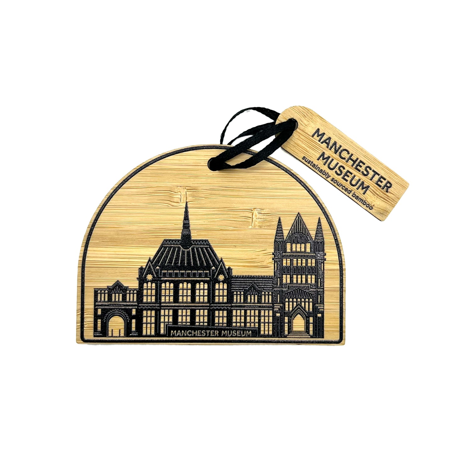 Semi circle bamboo decoration with a drawing of Manchester Museum. Bamboo label with Manchester Museum logo attached to black ribbon. White background.