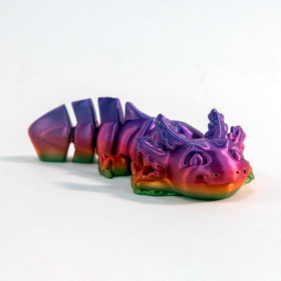 Segmented and rainbow coloured axolotl fidget toy on a white background.
