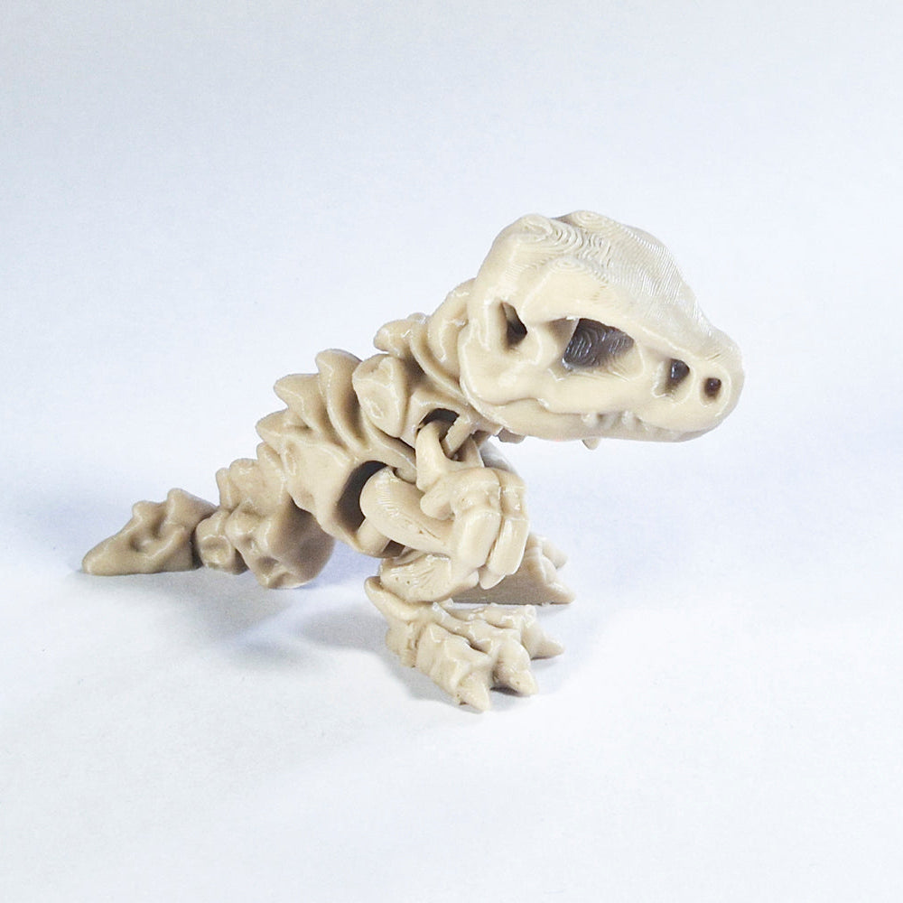 Segmented fossil T rex fidget toy on a white background.
