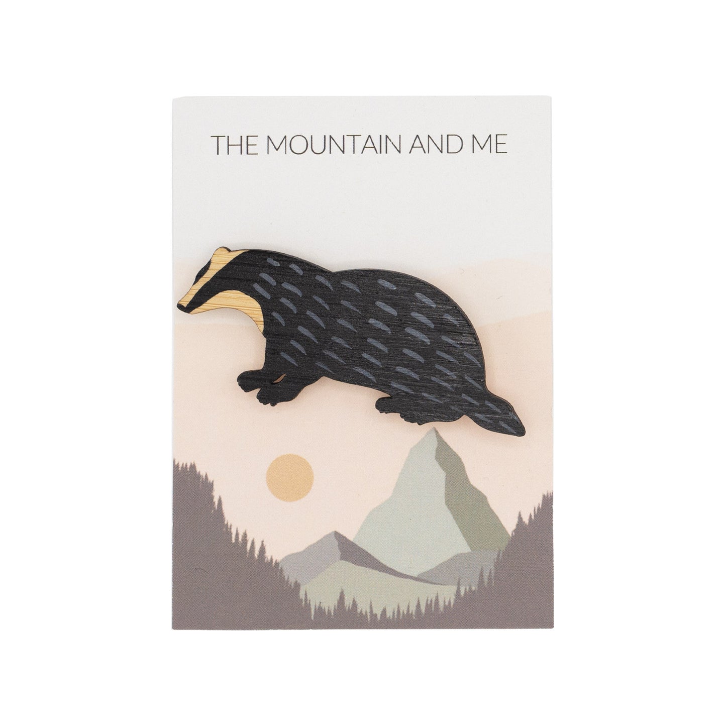 Bamboo brooch in the shape a badget against Mountain and Me branded backing card