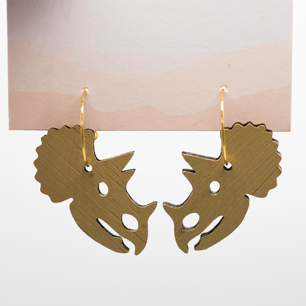 Pair of wooden triceratops-head-shaped earrings on a white background