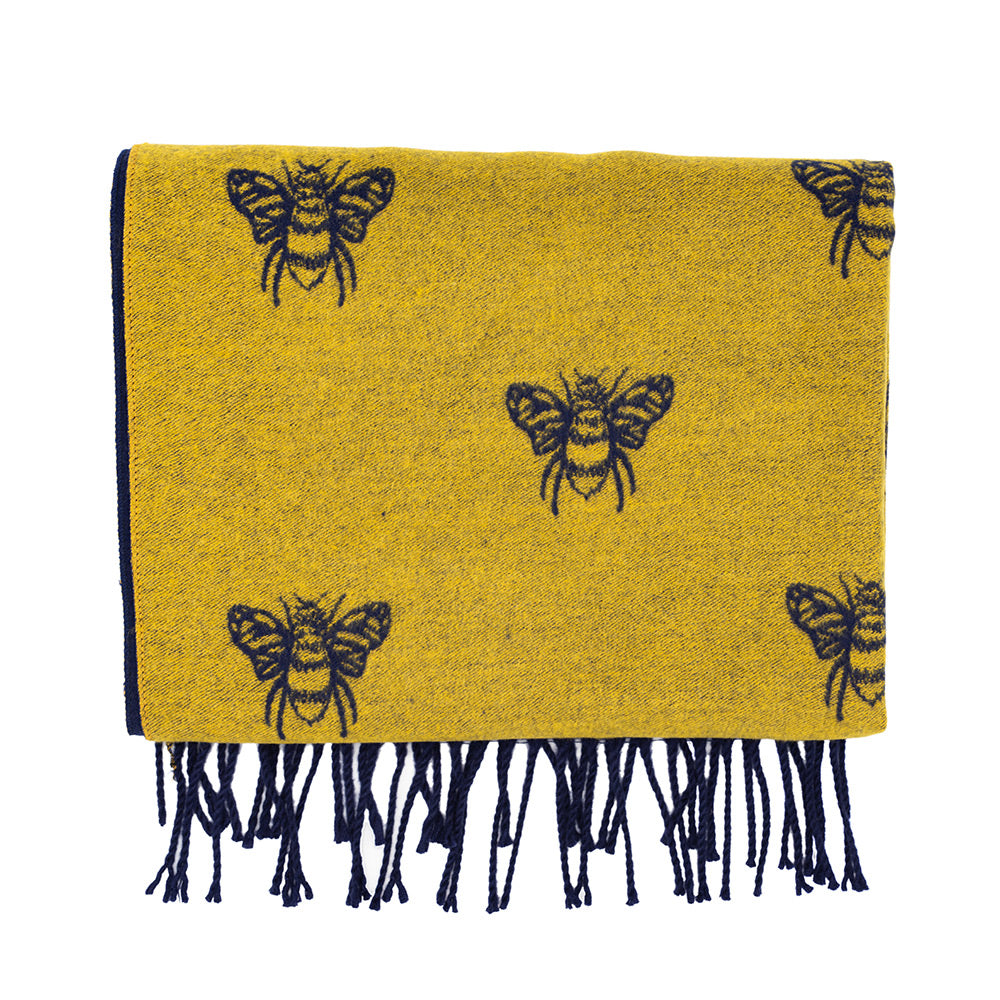 Folded mustard and navy bee scarf with the mustard side outwards.