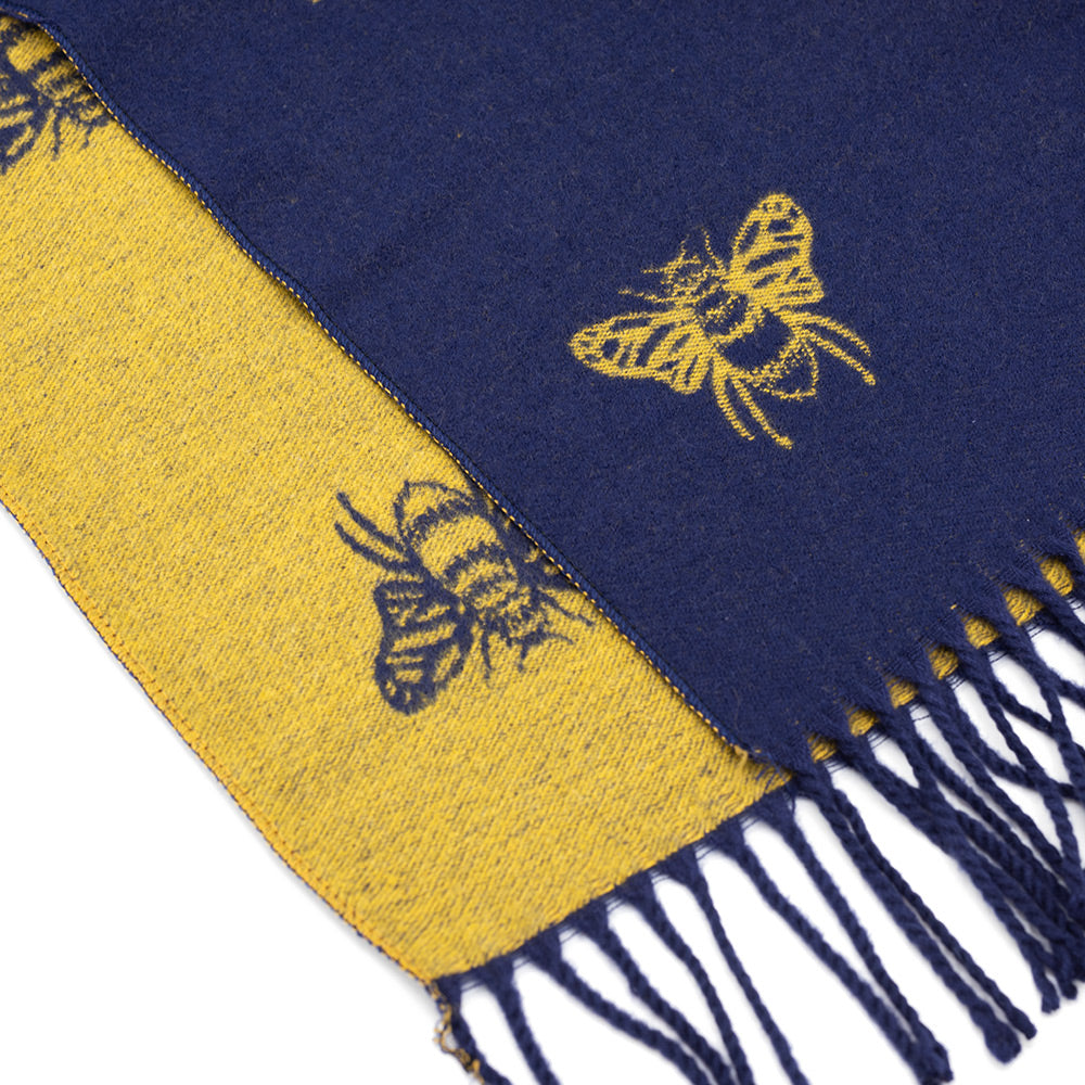 Close up of the ends of the mustard and navy bee scarf showing the twisted fringes.