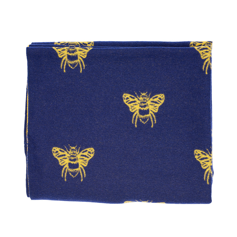 Folded up navy and mustard bee cashmere scarf showing the navy side with mustard bees.
