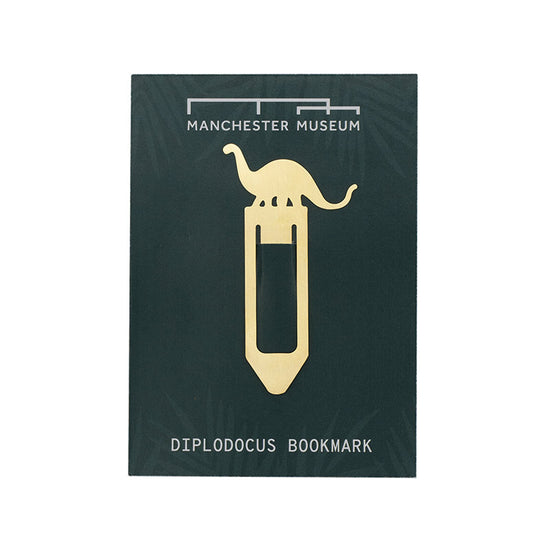 Brass bookmark with a dinosaur above ar rectangular shape, photographed in front of teal Manchester Museum branded backing card