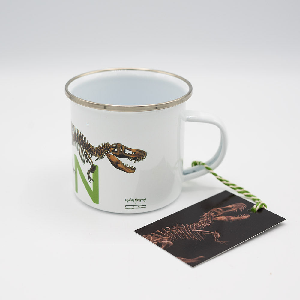 Mug with dinosaur design and a card on a white background