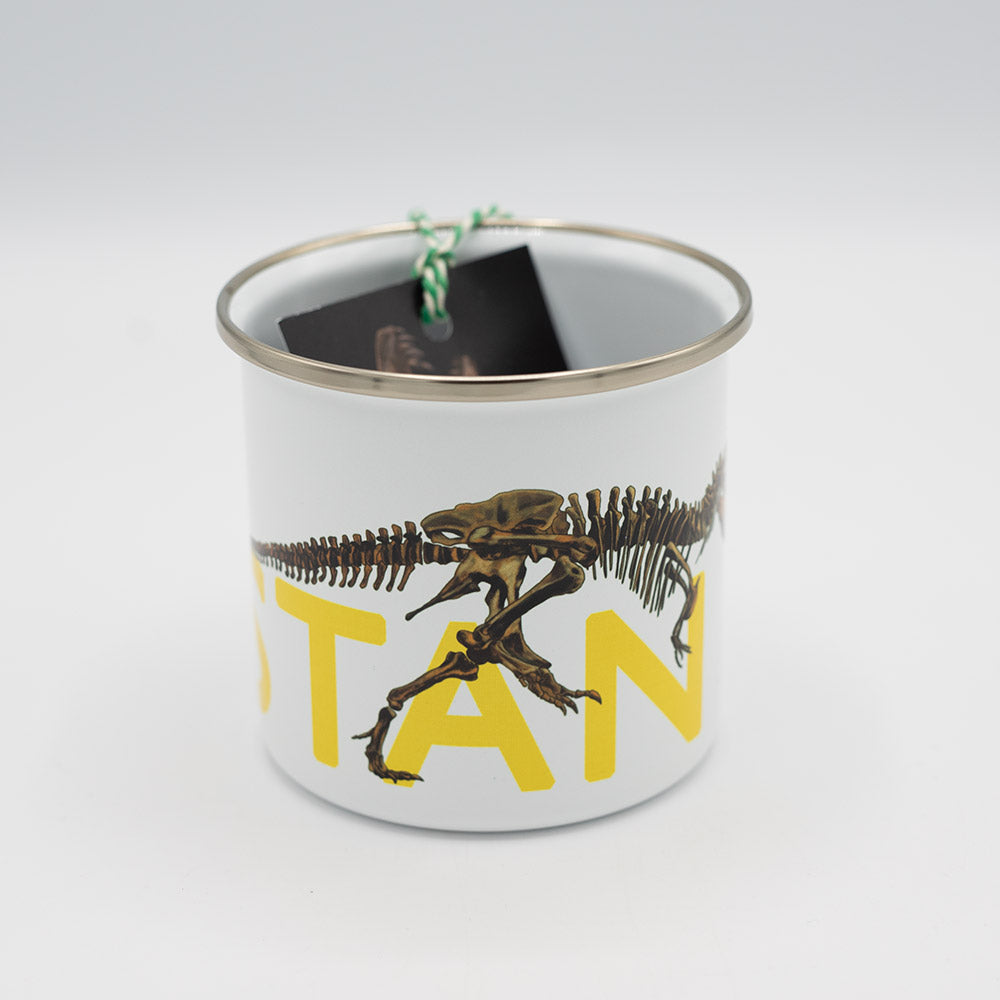 Enamel mug with dinosaur design and yellow text on a white background