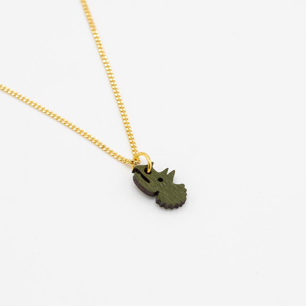 Gold chain necklace with a green triceratops head-shaped pendant on a white background