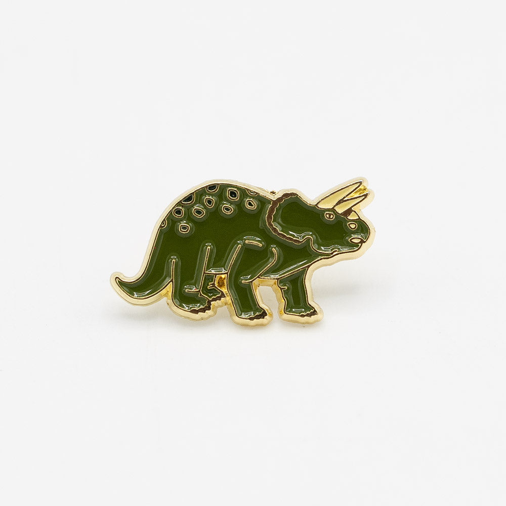 Green dinosaur-shaped pin with gold border on a white background