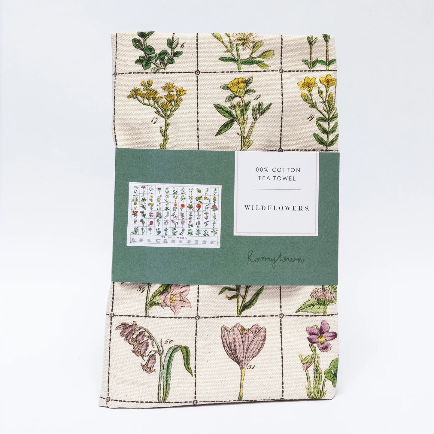 This is a folded cotton tea towel with a grid pattern and detailed illustrations of wildflowers, neatly packaged with a paper label.