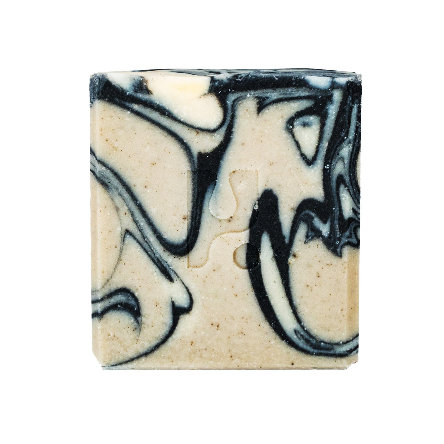 This is a close-up shot of a square bar of soap with a swirled pattern of black and light beige colours, isolated on a white background.