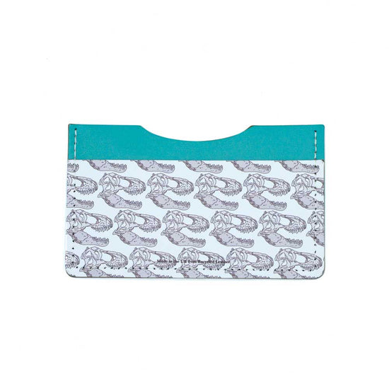 The turquoise and white recycled leather card wallet seen straight on from the back. The t-rex skull illustration is only present on the white leather along the bottom.