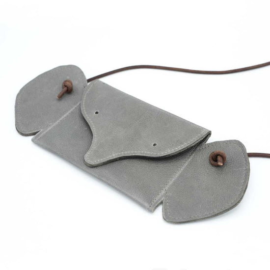 Grey leather bag shaped like an elephant seen from the front at a slightly angled view.
