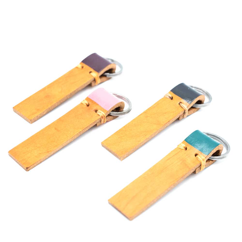 All four colours of keyrings laid out in a slightly zigzag pattern.