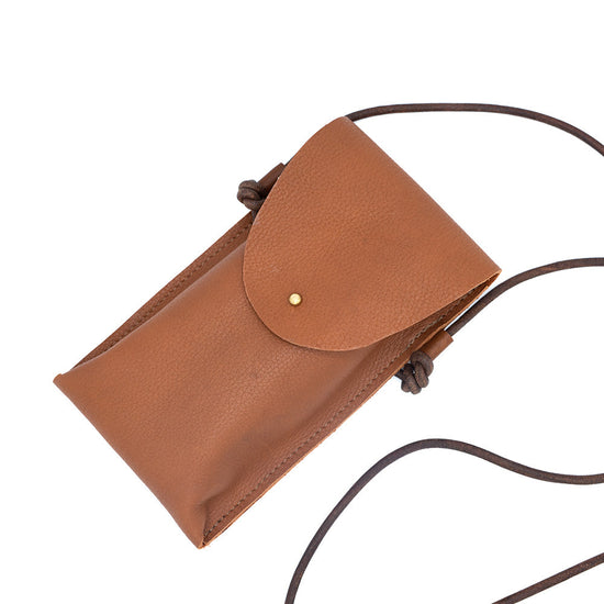 Brown phone leather bag seen from above with the darker brown leather strap on the right.