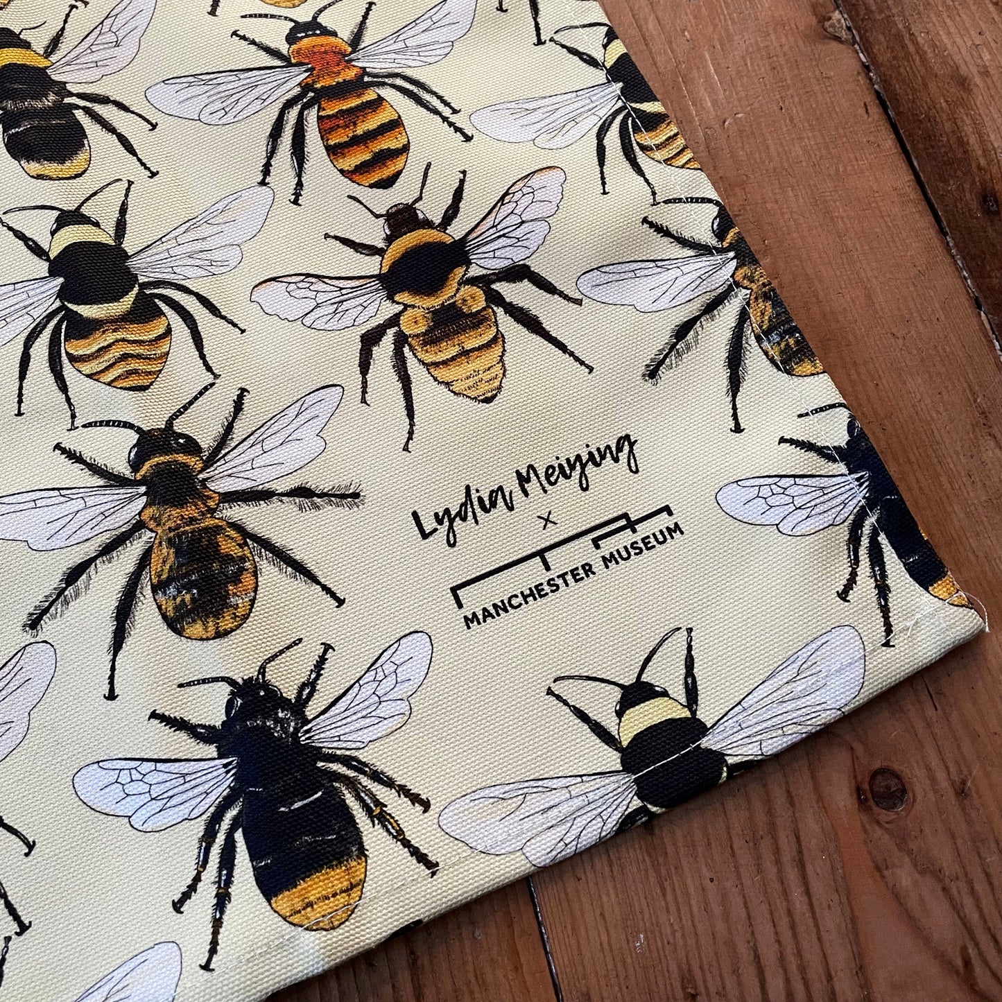 Close up of a corner of the tea towel showing the combined museum and Lydia Meiying branding.