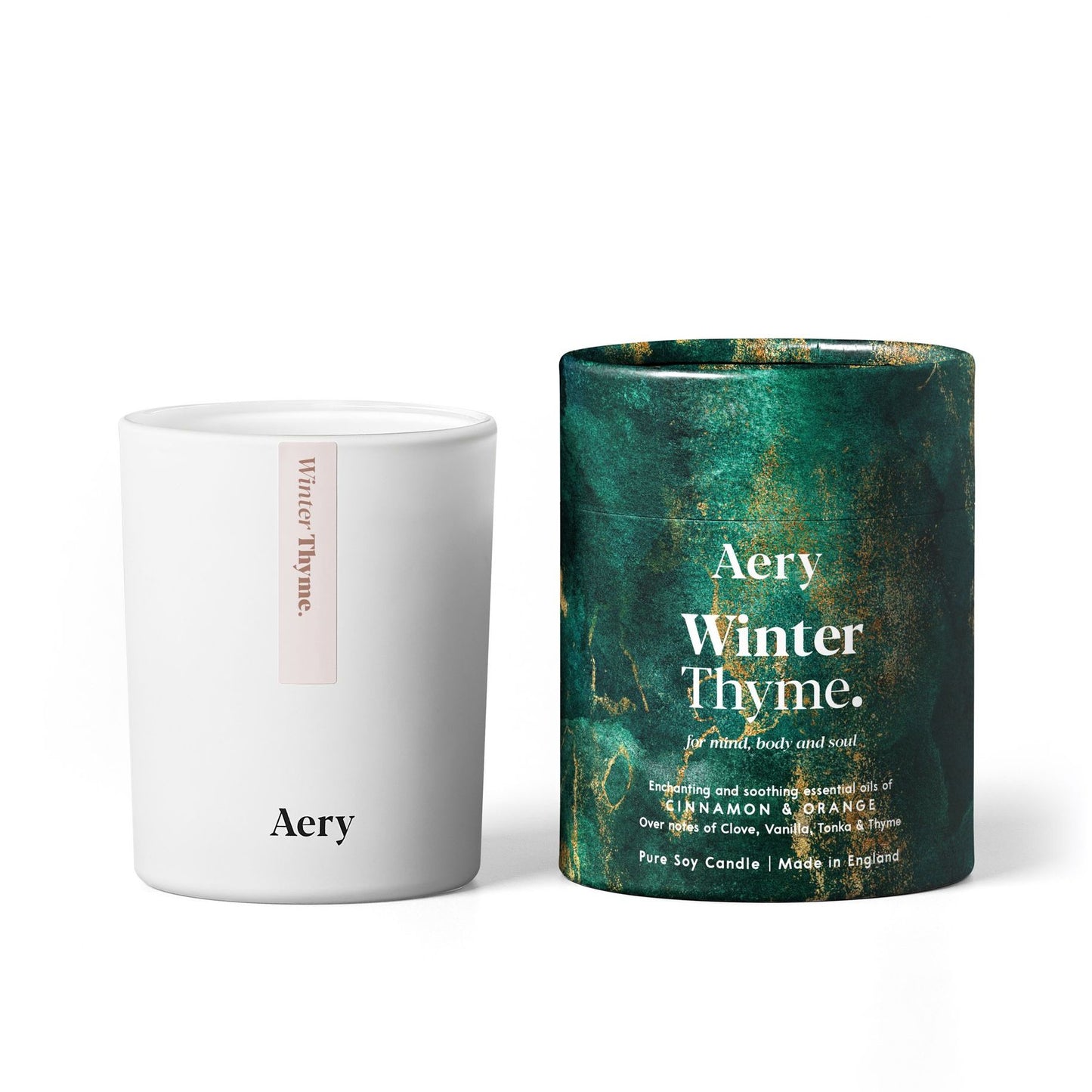 White Aery winter thyme candle with the green packaging card cylinder on the right.