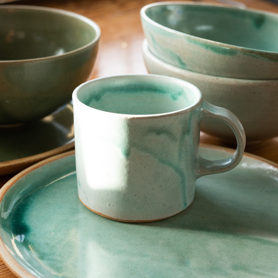 Blue glazed ceramic mug, plate and bowls. 