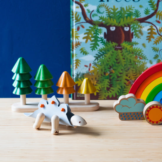 An photo of some kids products on a brown table in front of a blue wall