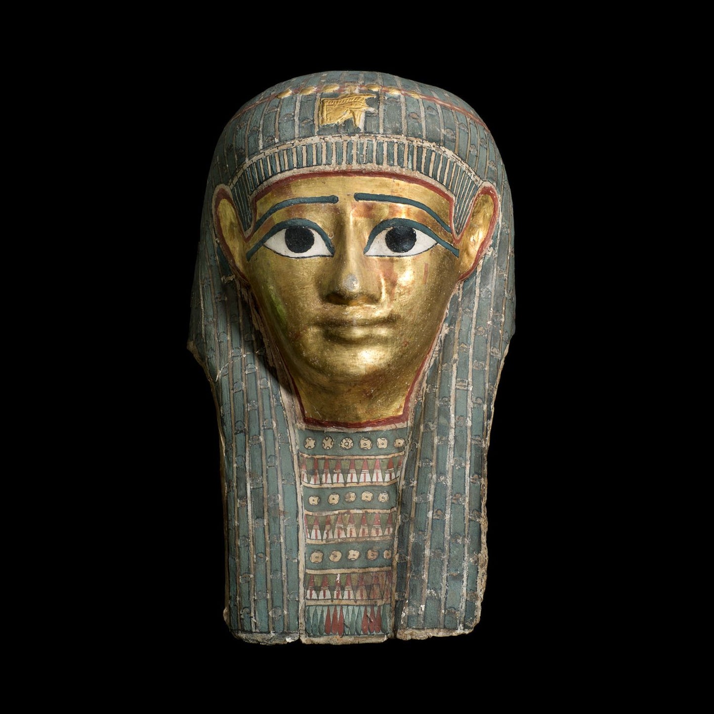Golden mummy mask with blue and red decorative panels from the neck down. Black backdrop.