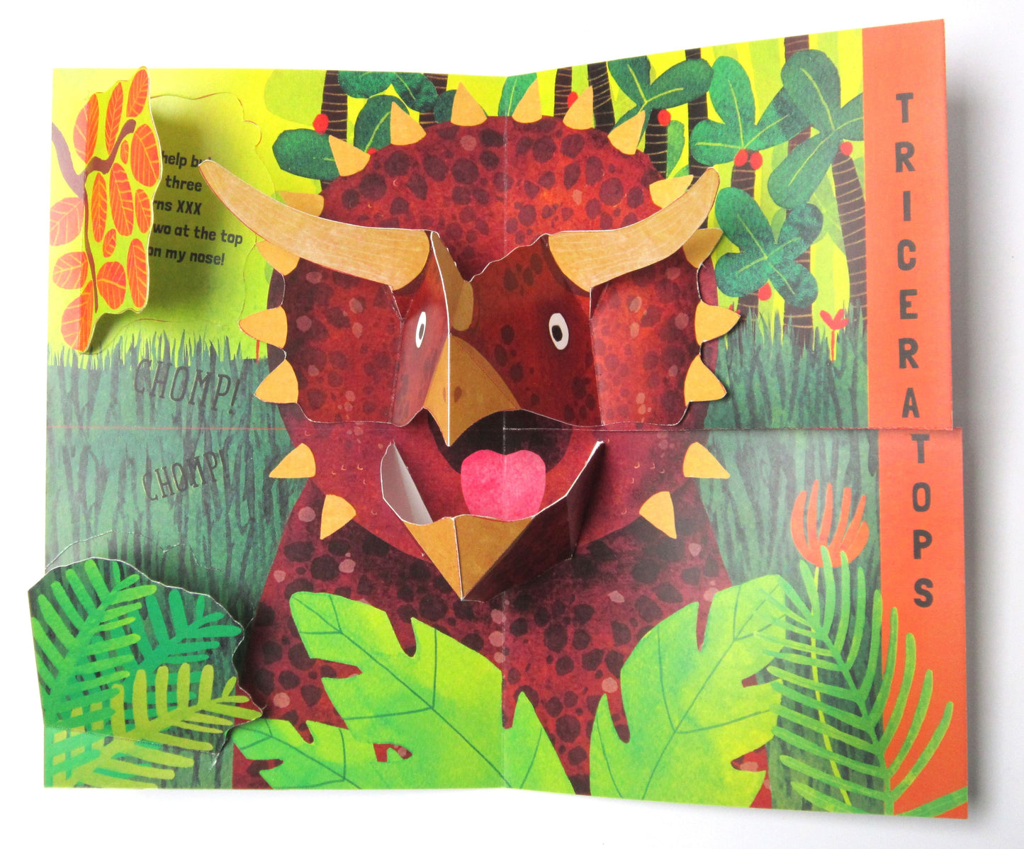 Colorful children's book inside spread with a triceratops pop out and jungle background.