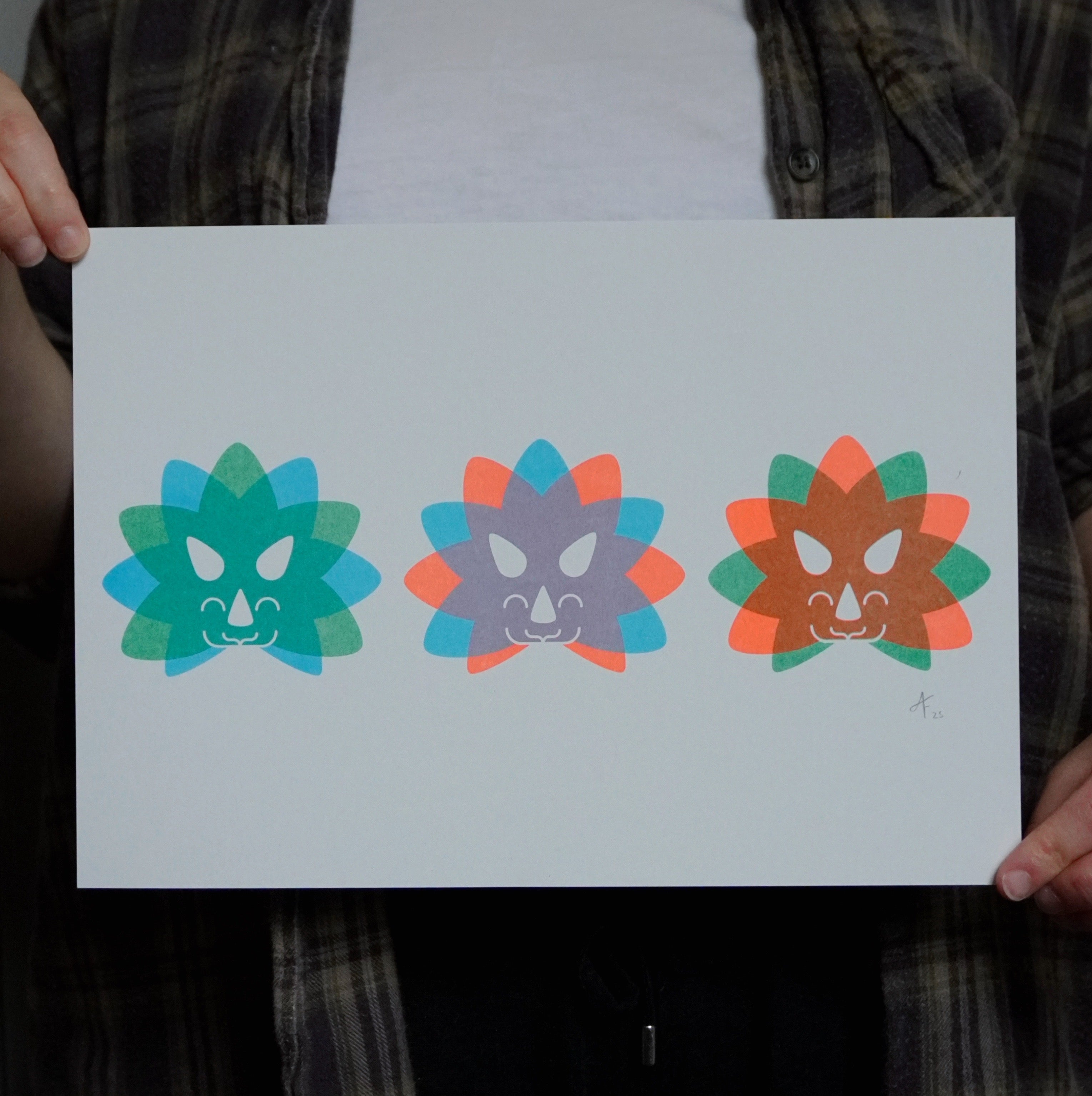 Three colorful Triceratops head designs held by a person.