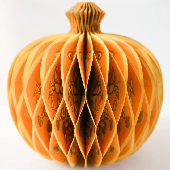 Decorative paper pumpkin on a white background.
