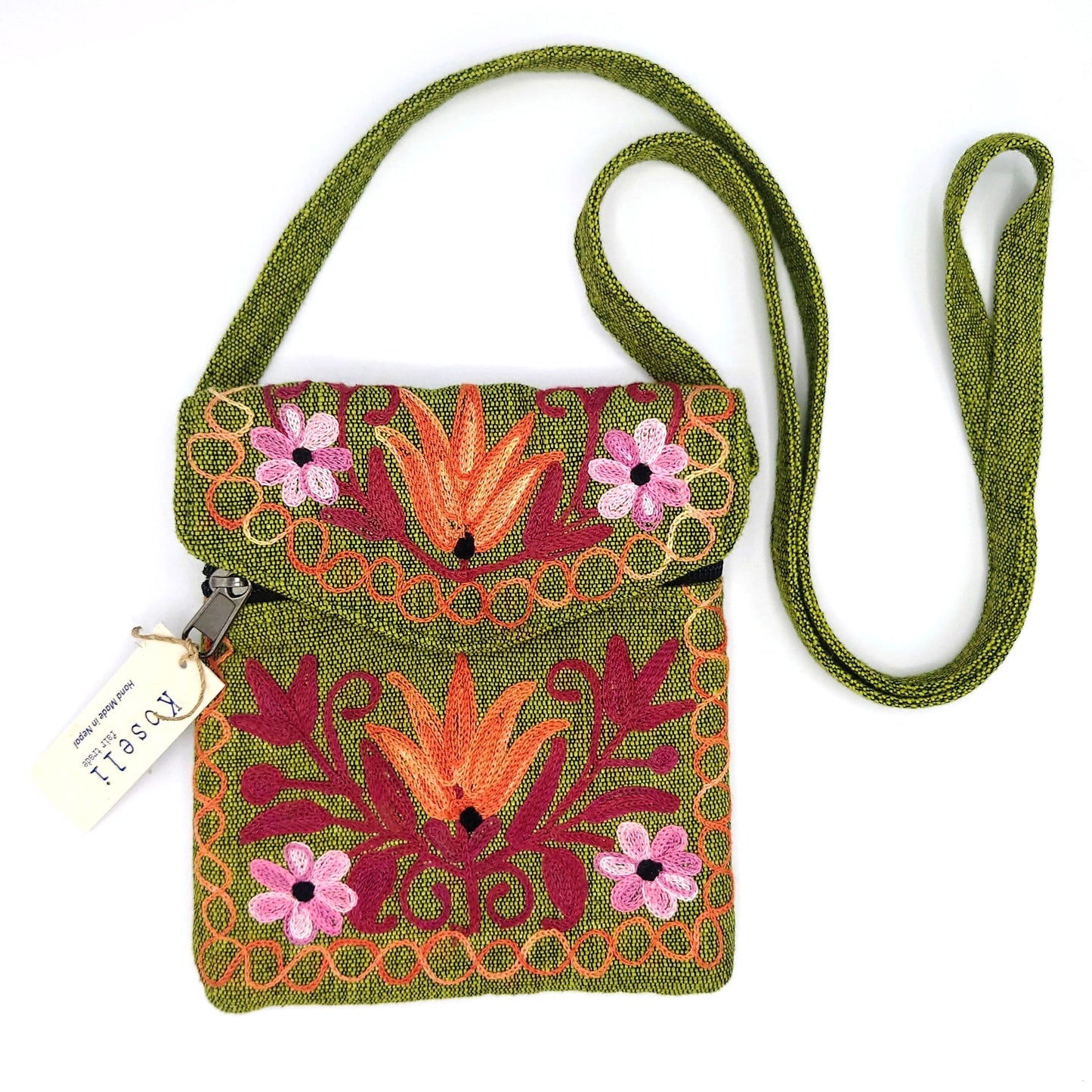 Green cotton back with strap. Red, orange and pink flowers embroidered across the front. Koseli tag on the zip to the left.