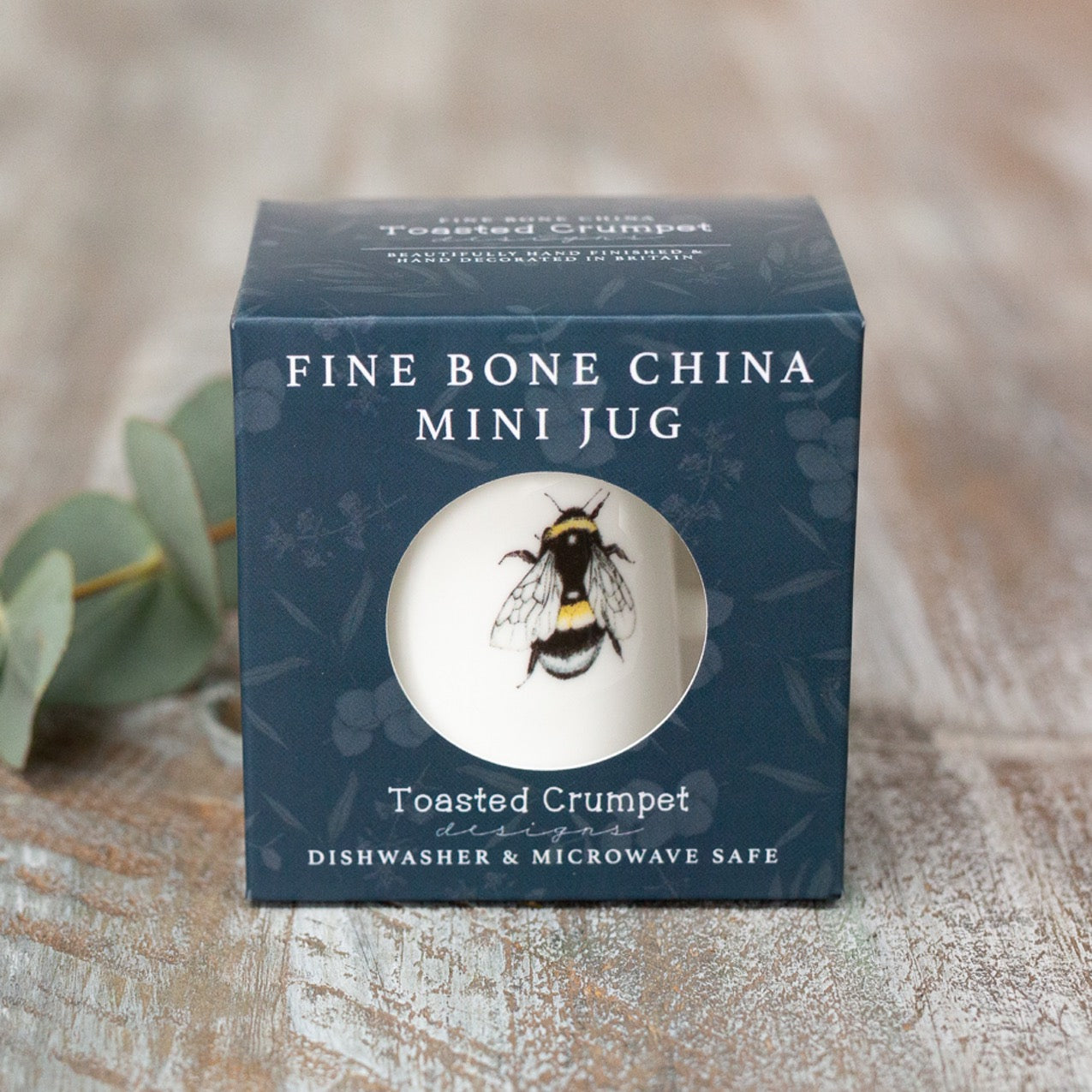 Box packaging for a fine bone china mini jug, photographed on a wooden surface.