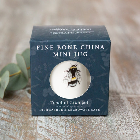 Box packaging for a fine bone china mini jug, photographed on a wooden surface.