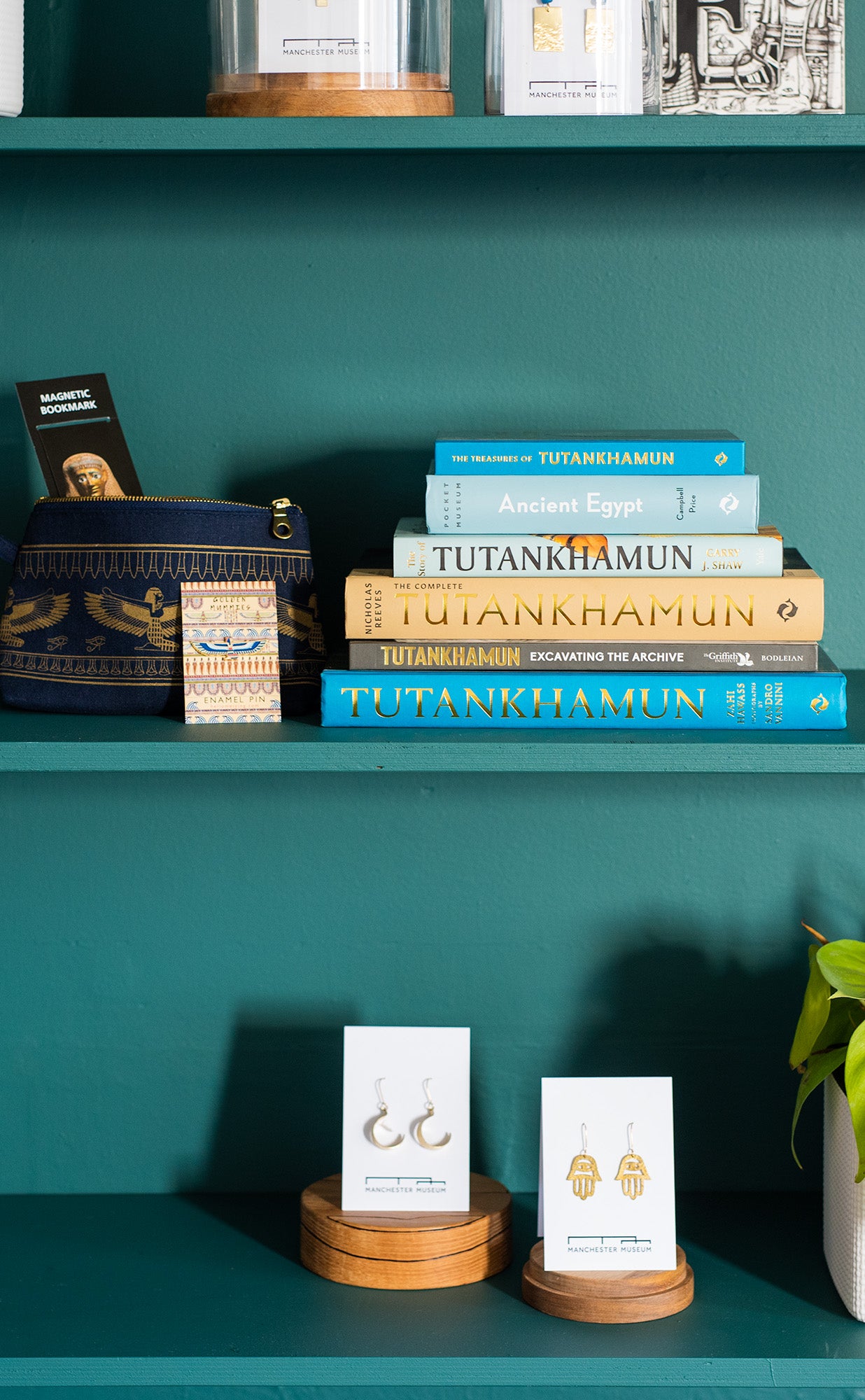 Golden Mummies collection books and products sat on teal shelves