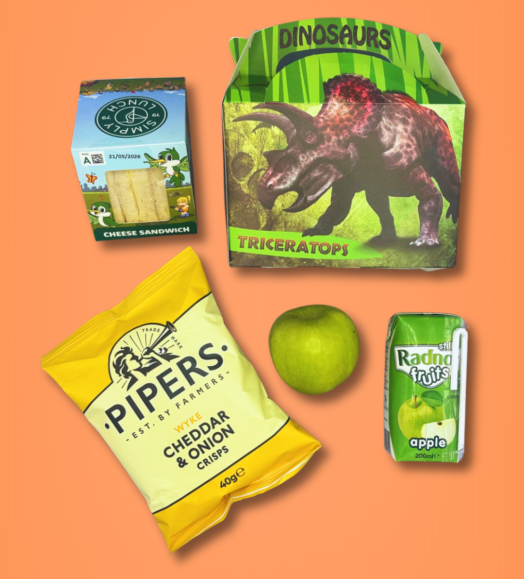 Assorted snacks including a cheese sandwich, cheddar & onion crisps, and apple juice on an orange background.