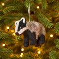 Wool felt badger ornament featuring distinctive facial markings and a hanging loop.