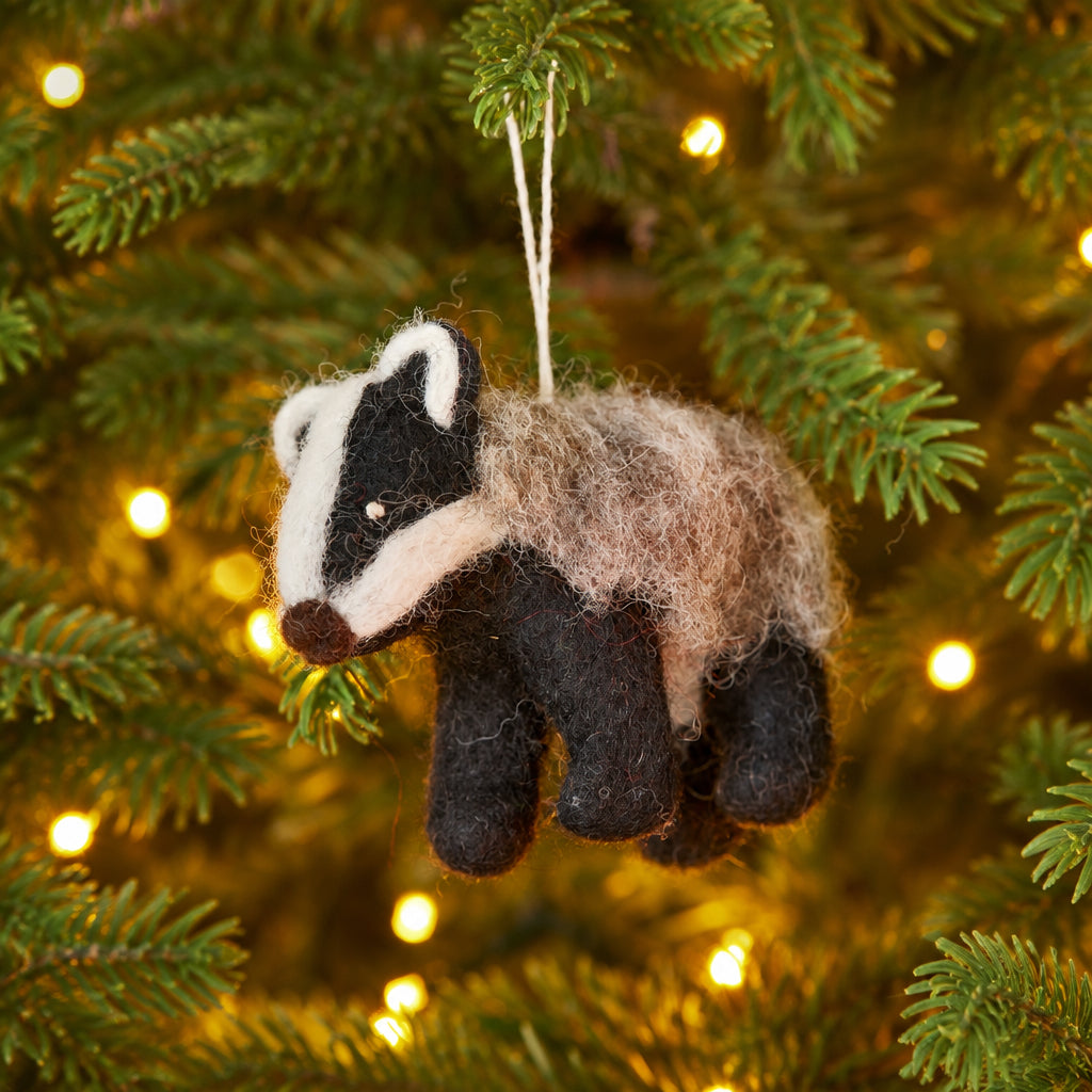 Wool felt badger ornament featuring distinctive facial markings and a hanging loop.