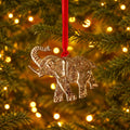 Gold-coloured elephant hanging decoration made from recycled aluminium, featuring an upturned trunk and suspended from a red velvet ribbon.
