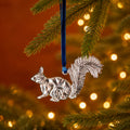 bushy-tailed squirrel decoration is made from recycled aluminium and hangs from a blue velvet thread.