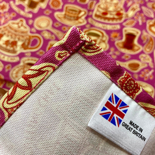 Tea towel close up of a 'Made in Great Britain' label on a patterned background