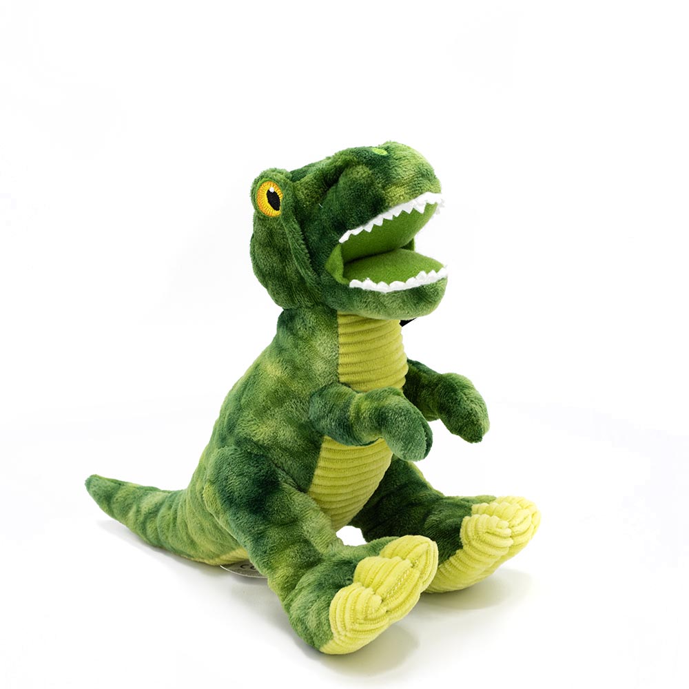 Green fabric toy in the shape of a T-Rex pin front of a white background.