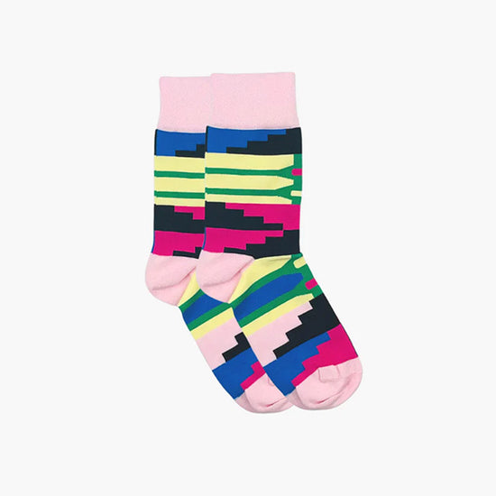 Pink, yellow, green and blue patterned socks with geometric shaped pattern photographed against white background.,