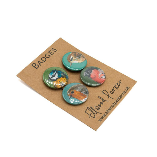 A set of four badges with different illustrations of birds presented on. branded backing card 