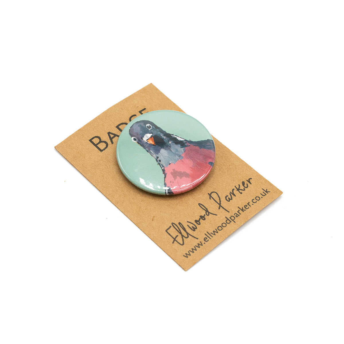 Badge with an illustration of a pigeon against branded backing card.