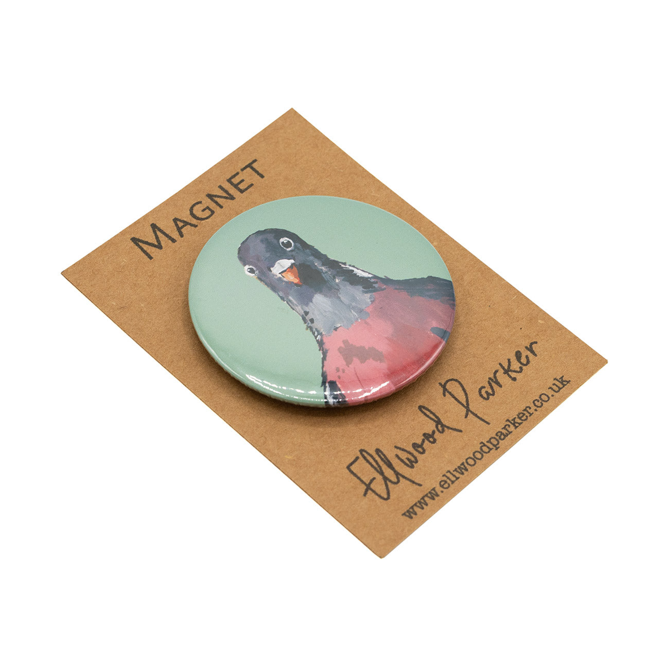 Photo of a round magnet with a pigeon illustration on it.