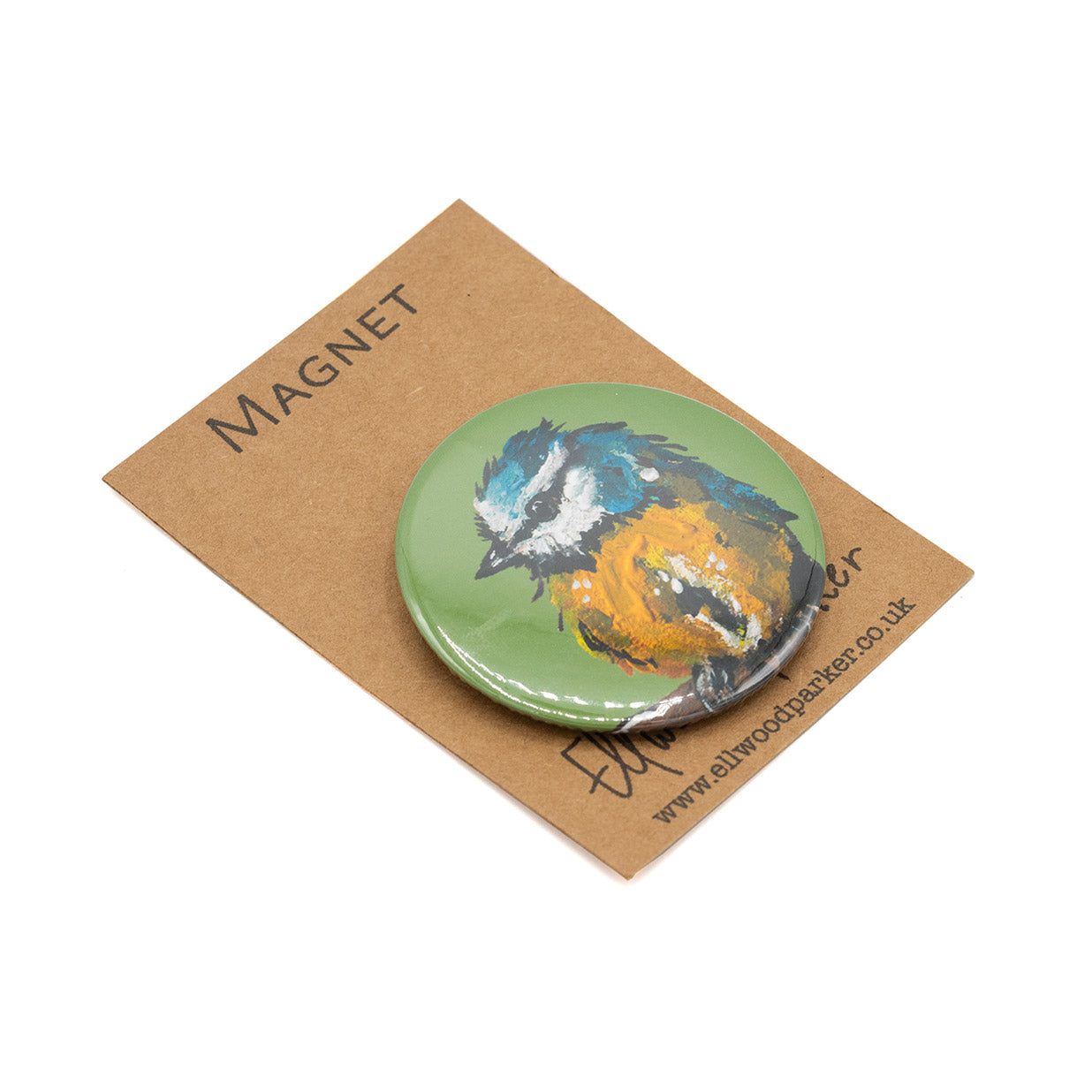 Photo of a round magnet with a blue tit illustration on it.