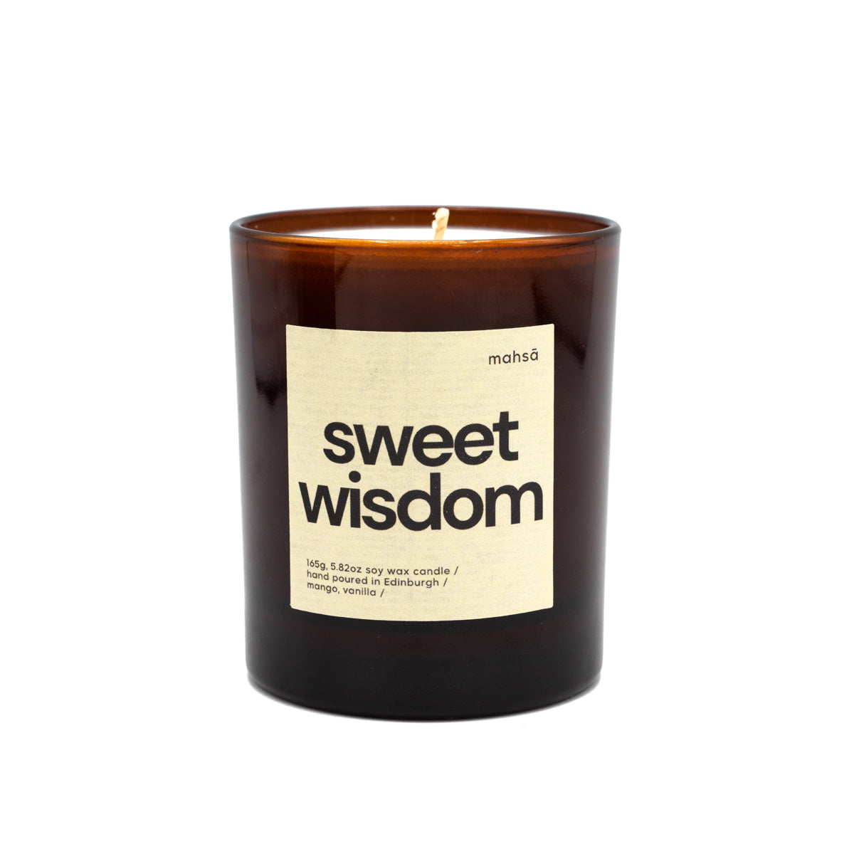 Soy wax candle in a brown glass jar with a label with the word's "sweet wisdom".