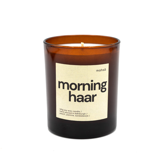 Soy wax candle in a brown glass jar with a label with the word's "morning haar".