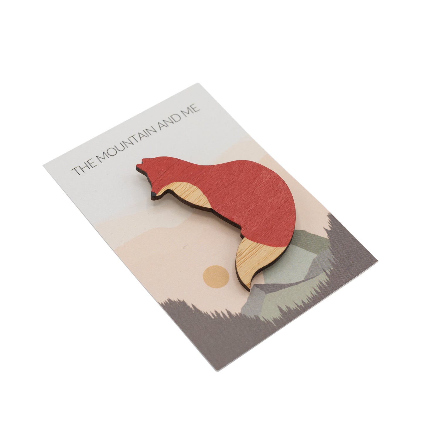 Wooden brooch in the shape of a red fox against branded The Mountain and Me backing card.