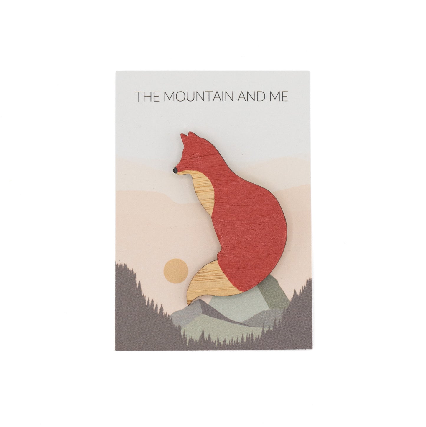 Wooden brooch in the shape of a red fox against branded The Mountain and Me backing card.