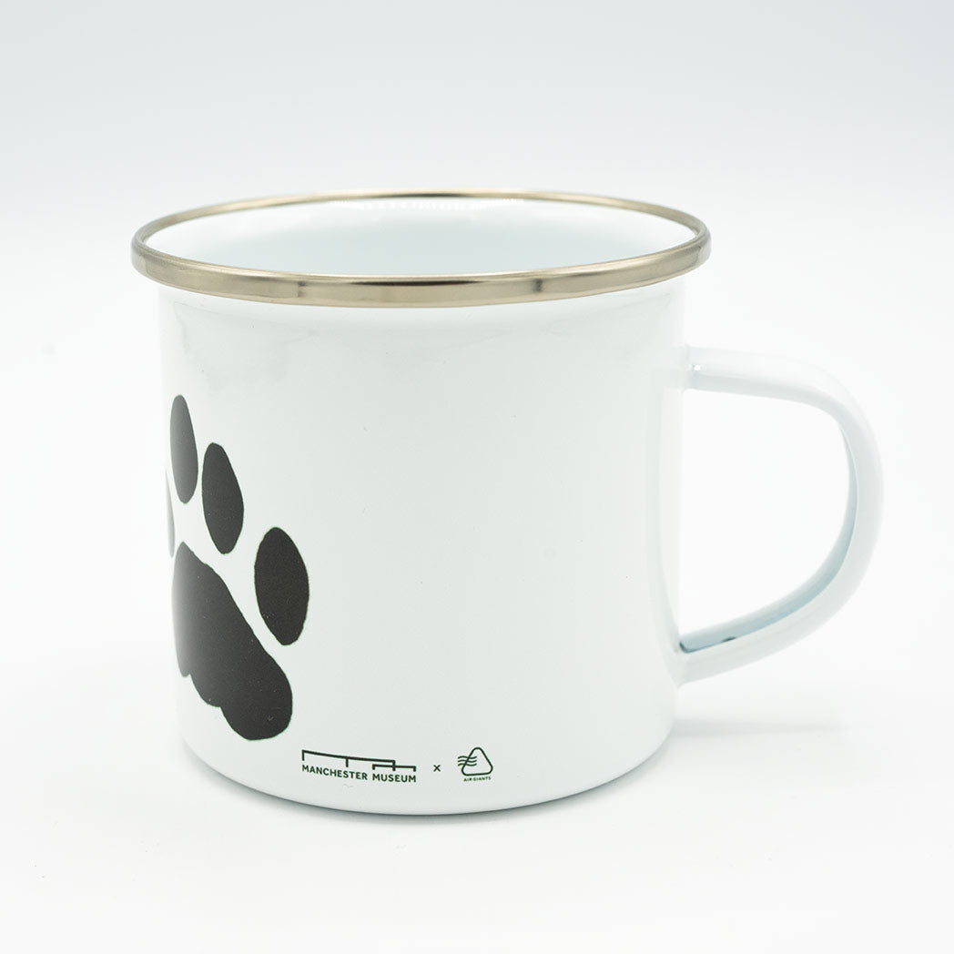 White mug with black paw print design on a white background